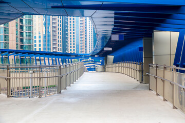 Modern futuristic overpass over the roadway in the city center.