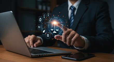 Legal Technology: A lawyer in a suit interacts with a glowing justice scale icon, integrating advanced digital solutions for modern law practice on a desk with a laptop.
