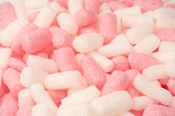 Pink and white box filler as a background. Top view.