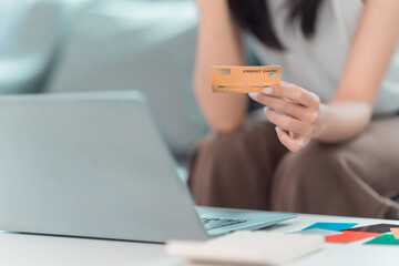 Shopping and paying online using laptop and tablet with credit card. Buying things online at home on e-commerce website in digital payment market. Close up.