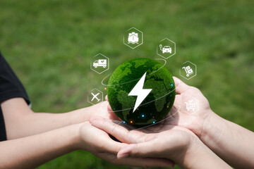 Hands Holding a Green Globe with Electric Symbol and Icons Around