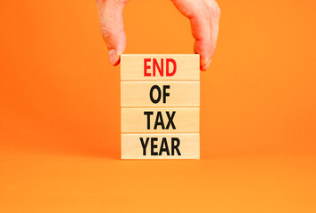 End of tax year symbol. Concept words phrase End of tax year on beautiful wooden blocks. Beautiful...
