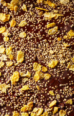 Chocolate bark with puffed quinoa and cornflakes on parchment