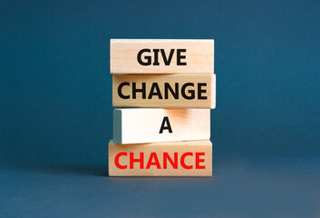 Naklejka premium Give change a chance symbol. Concept words phrase Give change a chance on beautiful wooden blocks. Beautiful grey paper background. Business Give change a chance concept. Copy space.