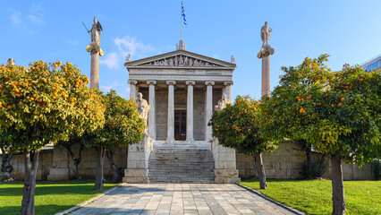 Facade of Athens Academy with statues of Plato and Socrates in front.