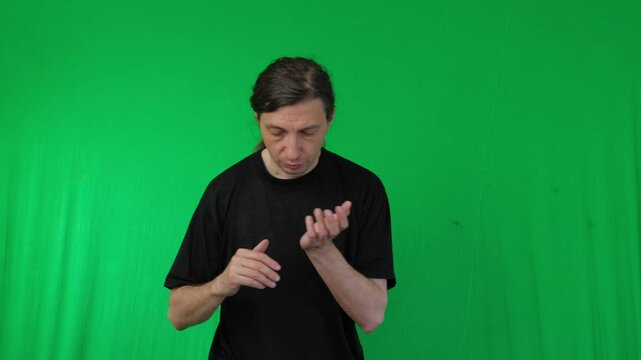 A man is shown in a martial arts stance, seemingly practicing a Kung Fu move against a vibrant green screen background. His body is positioned for action, conveying discipline and training