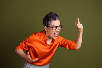 Confident and expressive woman gesturing with enthusiasm on a khaki background, demonstrating...