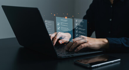 Man in twenties completing a digital checklist on a laptop, signifying task management and online compliance.