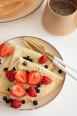 Fresh crepes with mixed berries and coffee.