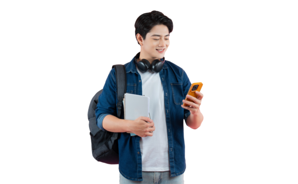 Portrait of Asian male student wearing headphones and backpack , holding phone and pointing finger gesture posing on PNG background	