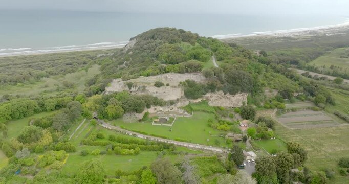 Aerial view of the archaeological excavations of Cuma, in the province of Naples, Campania, Italy. On the hill are the remains of the ancient city of Cumae, one of the oldest Greek colonies in Italy.