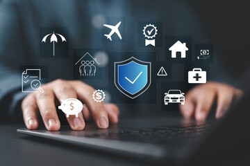 Insurance concept. Businessman using a laptop with various digital icons representing different types of insurance, such as health, home, car, travel, comprehensive coverage, and policy management.