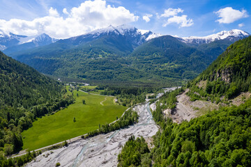 Clouds rolling over snow capped peaks in the Ecrins Mountains of the French Alps