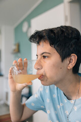 Teenager girl drinking juice in the morning, following daily routines