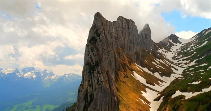 Majestic mountain landscape showcases rugged peaks and scenic valleys under a dynamic sky