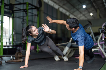 Fototapeta premium Wellness and Friendship. Friends having fun during a workout session at the gym.