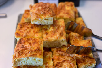 Bakery .Home made  cheese pie  with phyllo pastry, feta cheese  and organic eggs. Bulgarian banitsa. Brekfast on a display at Hotel