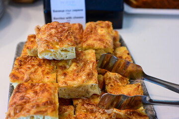 Bakery .Home made  cheese pie  with phyllo pastry, feta cheese  and organic eggs. Bulgarian banitsa. Brekfast on a display at Hotel