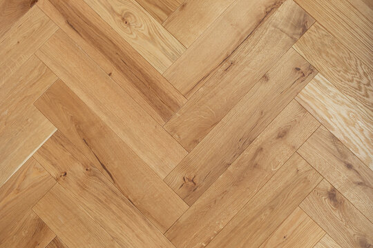 Natural wooden oak parquet flooring background. Rustic floor pattern for interior and indoor home design top view.