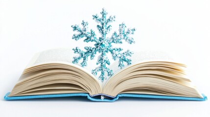 Fototapeta premium An open book with a blue snowflake decoration above its pages on a white background.