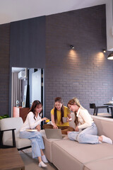 Asian Young Women Shopping Online with Laptop and Credit Card in Living Room Enjoying Time Together at Home Relaxing and Laughing