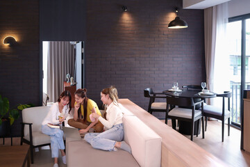 Asian Women Teamwork on Laptop in Modern Apartment Studying and Collaborating on Project Together Idea Sharing in Cozy Living Space with Natural Light and Stylish Interior Design