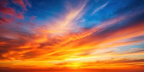 Obraz premium Warm sunset sky with a blurred gradient background featuring shades of red and orange hues, set against a soft, pastel blue sky at dusk , blurred effect, orange gradient