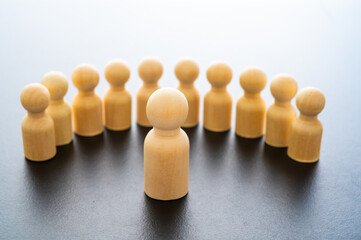 Conceptual representation, with wooden pawns, of a person who addresses other people who listen....