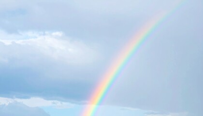 Pastel Rainbow Arch Against Cloudy Sky