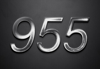 Chrome metal 3D number design of 955 on grey background.