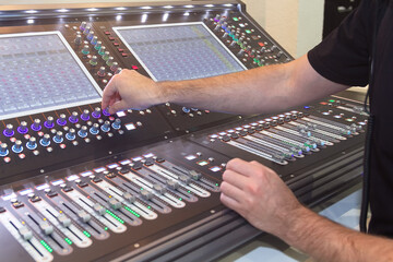 Sound engineer hands adjusting control sound mixer in recording, broadcasting studio