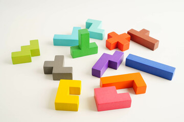 Fototapeta premium Logical thinking and problem solving problem solution creative business, wooden puzzle geometric block shape.