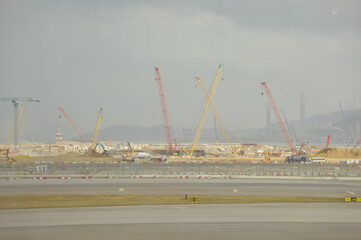 Construction site in Tung Chung, Hong Kong. Cranes truck working in construction site. Construction background, construction equipment crane background.
