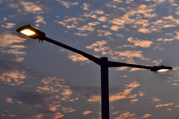 Close-up of the street light. Lighting in outdoors. Light bulb. Lighting in the city. Lamppost concept. Cityscape. Lighting equipment.
