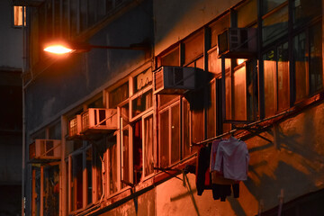 Close-up of the residential building in Hong Kong at night. Building exterior. Hong Kong cityscape, street scene. Travel and cityscape concept.