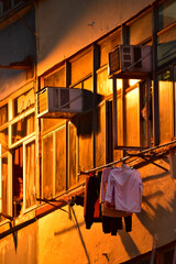Close-up of the residential building in Hong Kong at night. Building exterior. Hong Kong cityscape, street scene. Travel and cityscape concept.