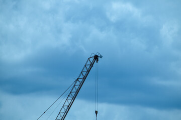 Crane truck working in construction site with sky background. Crane against sky. Crane, Construction background, construction equipment crane background.