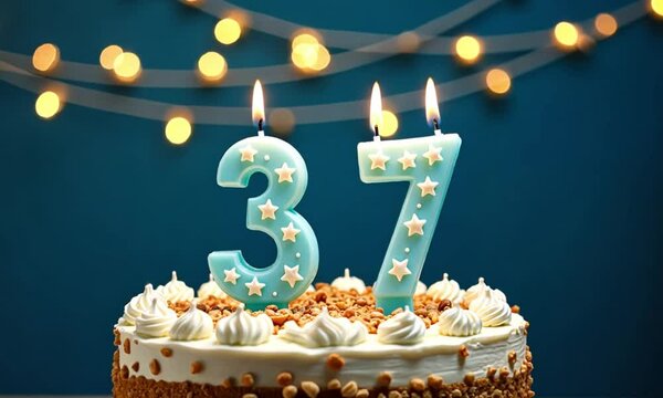 Birthday cake with lit candles, number 37