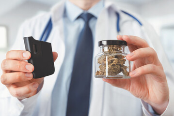 Doctor holding medical CBD herb and vaporizer.