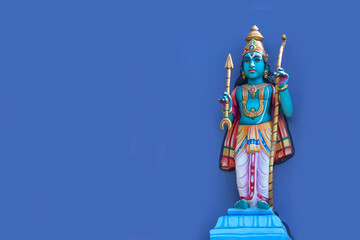 Vishnu Avatar Rama with Bow and Arrow Statue on Purple Wall Background