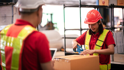 Factory worker,Shipping Team in Distribution Warehouse Packing Products for Delivery with Colleague...