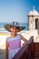 Beautiful young girl tourist wearing a sombrero vueltiao in Cartagena. Colombian people. Travel concept.