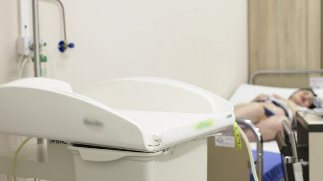 A pregnant woman with an electrocardiograph on her abdomen. Checking the baby's condition before delivery. Fetal heart monitoring. Diagnostics, health care, medical services