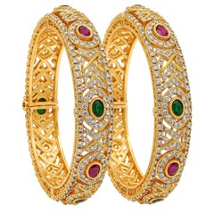 Obraz premium Two golden bangles isolated on white background with gems
