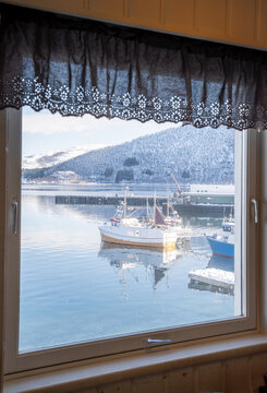 Fototapeta Scenic view of fishing boats through a window in Botnhamn