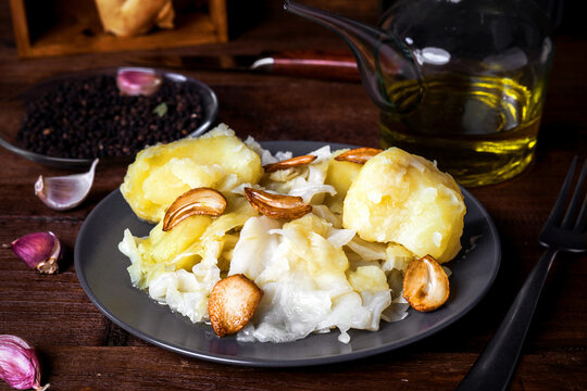 Homemade cabbage stew with potatoes on rustic wood stage