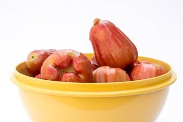 Rose apple fruit (syzygium jambos) isolated on white background. Rose apples have a variety of...
