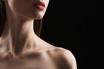 Woman with perfect skin on black background, closeup. Space for text