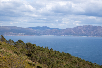 Finisterre, Galicia, Spain; April 6, 2025:  Panoramic shot from Mirador de Fisterra featuring the Atlantic horizon, steep cliffs, and the Finisterre lighthouse.  Atlantic coast. 