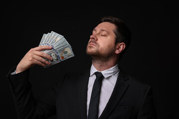 Greedy banker waving money on black background